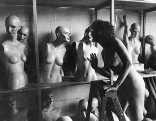 United States: A Nude Woman on a Ladder Chats with a Mannequin Head